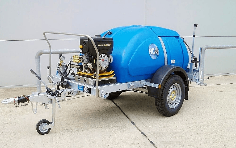 Blue mobile water and slurry bowser trailer used for professional driveway restoration